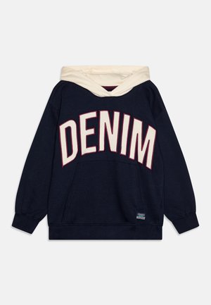 Marineblå hoodie med en cremefarvet hætte og store "DENIM" bogstaver i hvid med maroon kant. Har en kengurulomme og ribbede manchetter.