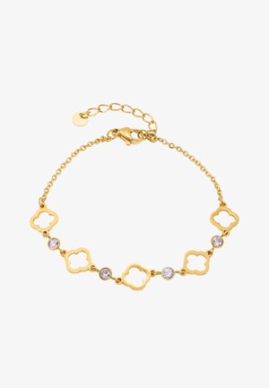 Náramok zo zlatej reťaze s článkami v tvare štvorlístka a tromi čistými kameňmi. Hladká textúra s lešteným povrchom a nastaviteľnou sponou.