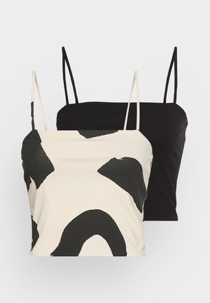 Kahden naisen lyhyet toppaliivit ohuilla hihnoilla; yksi musta, toinen beigen värinen, jossa suuret abstraktit mustat kuvioinnit.