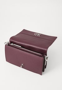 Calvin Klein CONVERTIBLE MINI BAG - Cross body bag - vineyard wine