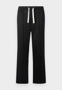 Black sweatpants with a drawstring waist in cream. Made from a smooth material, featuring straight legs and no visible pockets.