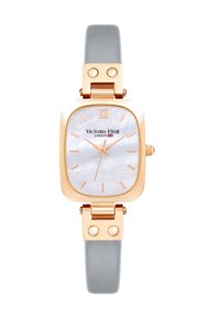 Rektangulært ur med et urkasse i rosaguldfarvet metal, gråt tekstureret læderrem og urskive i perlemor med gyldne timeindikatorer.