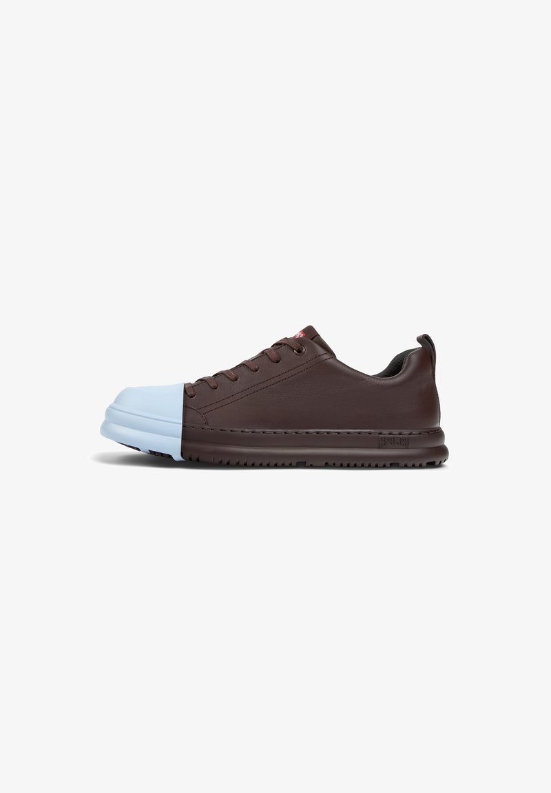 Brown leather sneaker with light blue rubber toe cap and brown sole. Features lace-up design, textured side panels, and red logo detail.