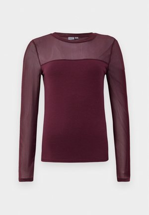 Bordowy top z długim rękawem o gładkiej części i przezroczystych siateczkowych rękawach. Okrągły dekolt z kontrastową teksturą na ramionach. Lekki materiał.