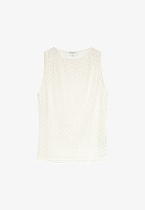 Top sans manches blanc en tissu texturé avec un motif géométrique. Encolure ronde et coupe décontractée, avec des coutures le long de l'ourlet.