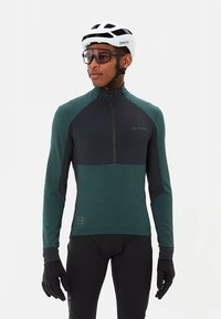 Fietsjersey met een half-rits ontwerp, uitgevoerd in teal en donkergrijze panelen. Lange mouwen, nauwsluitende pasvorm en reflecterende accenten voor zichtbaarheid.
