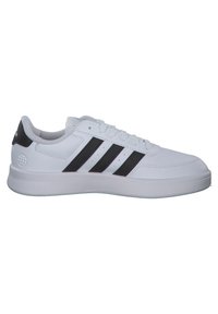 White athletic shoe with three black stripes, smooth synthetic upper, laced front, padded collar, and rubber outsole.