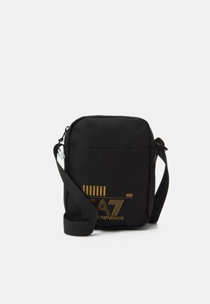 TRAIN CORE POUCH BAG UNISEX - Cross body bag - black/yellow