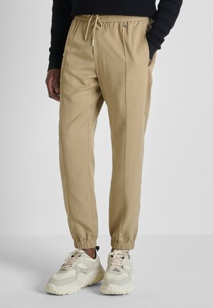 NATE REGULAR FIT - Trainingsbroek - beige