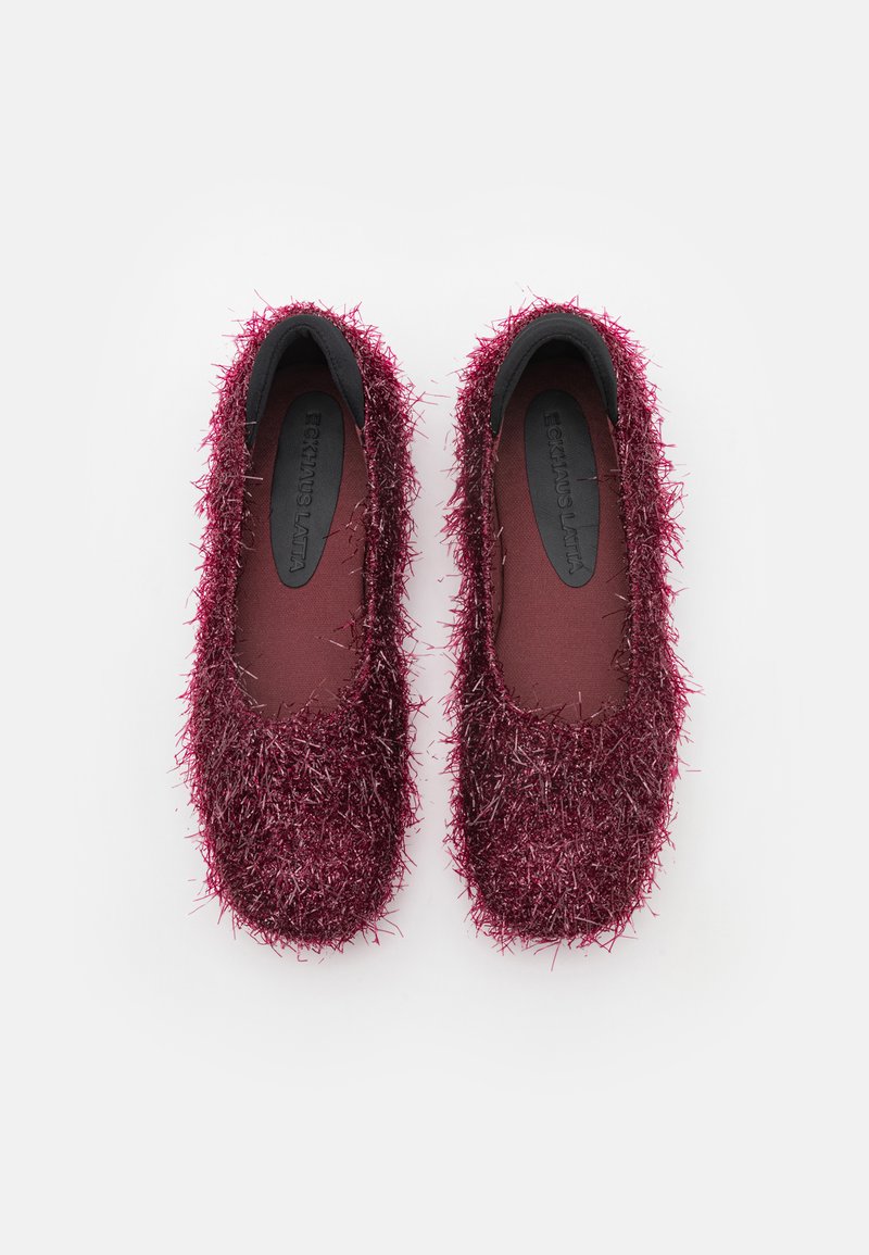 Burgundy shoes with a textured, shaggy synthetic upper, featuring a simple slip-on design and a smooth black insole.