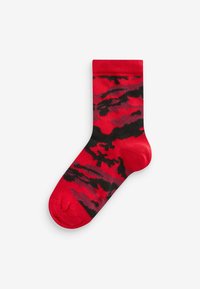 R�ød og sort ankelstrømpe med camouflage-mønster, lavet af blødt materiale med ribbet manchette og en glat tekstur.
