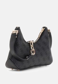 Borsa a spalla nera strutturata con materiale testurizzato, dettagli in oro e contrasti in pelle. Presenta una chiusura con zip e una tracolla.