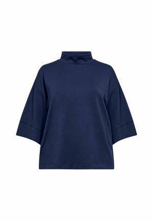 Tummansininen lyhythihainen paita, jossa on korkea poolokaulus ja löysä malli, esillä valkoista taustaa vasten.