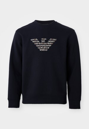 Marineblauwe sweatshirt met ronde hals en lange mouwen, voorzien van een gemarmerd adelaarslogo met de initialen "GA" gecentreerd op de borst.