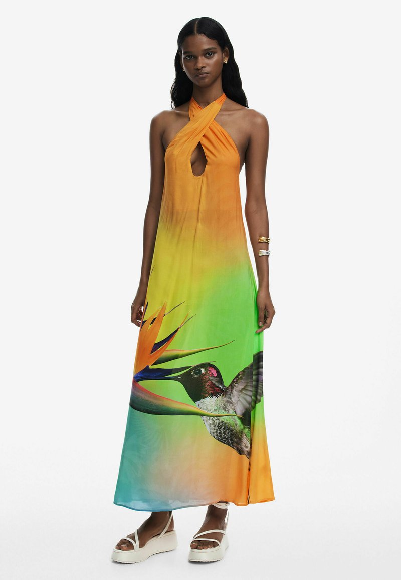 Long, halter-neck dress featuring a gradient from orange to green, with a keyhole cutout and a bird of paradise design with a hummingbird.