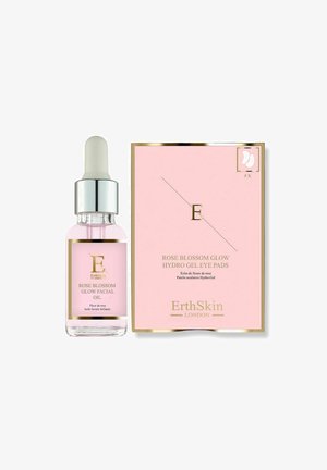 Butelka olejku do twarzy Rose Blossom Glow z zakraplaczem obok różowo-złotego opakowania płatków pod oczy Rose Blossom Glow Hydro Gel marki ErthSkin.