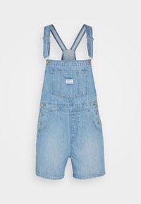 Salopette in denim blu chiaro con bretelle regolabili, tasche frontali e dettagli in bottone sui lati. Presenta una tasca posteriore con etichetta.