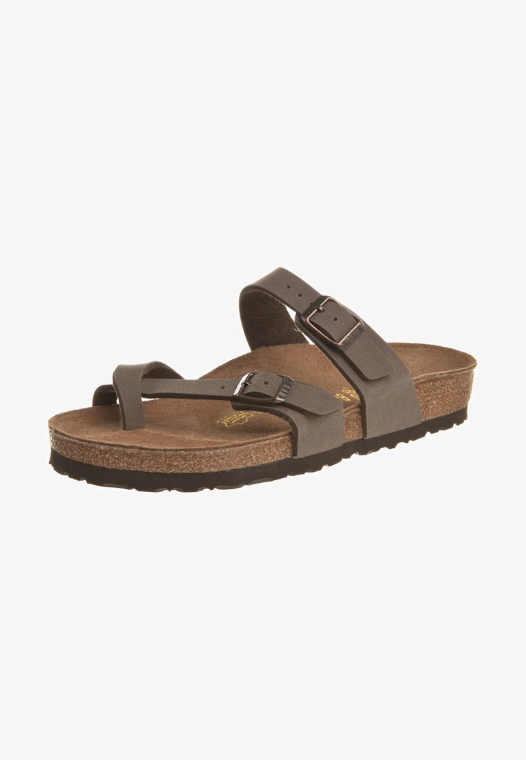 Brown cork-footbed sandal featuring two adjustable straps with a metallic buckle, textured surface, and a sturdy black rubber outsole.