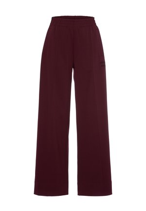 Burgunderfarbene Hosen mit weitem Bein aus weichem Stoff, mit einem elastischen Bund und seitlichen Taschen. Ein kleines gedrucktes Logo-Detail befindet sich an der Seite.