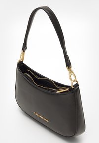 Black leather handbag with a curved shape, featuring a gold zipper and hardware accents. Interior has multiple compartments. Brand logo displayed.
