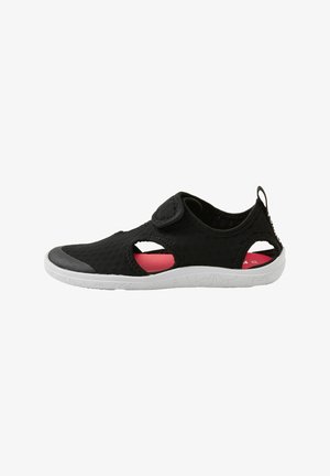 Black mesh shoe with prominent cutouts, a hook-and-loop strap, and a white rubber sole. Interior features pink accents and textured surface.