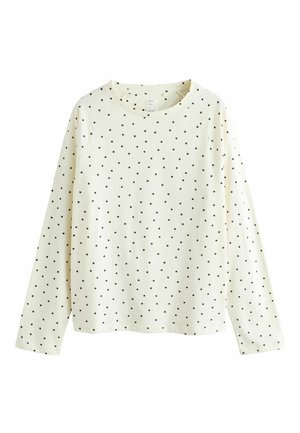 Langärmliges cremefarbenes Oberteil mit schwarzen Polka-Dots, ausgestattet mit Rundhalsausschnitt und Raglanärmeln. Hergestellt aus weichem Stoff mit glatter Textur.