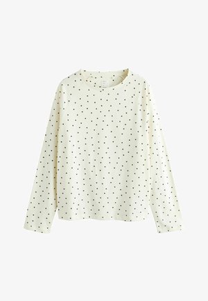 Langärmliges cremefarbenes Oberteil mit schwarzen Polka-Dots, ausgestattet mit Rundhalsausschnitt und Raglanärmeln. Hergestellt aus weichem Stoff mit glatter Textur.