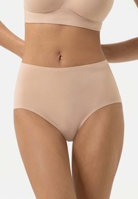 Beige high-waisted briefs made of smooth fabric, featuring a seamless design and elastic waistband for comfort and coverage.