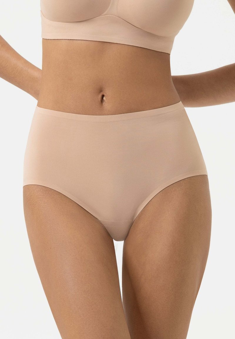 Beige high-waisted briefs made of smooth fabric, featuring a seamless design and elastic waistband for comfort and coverage.