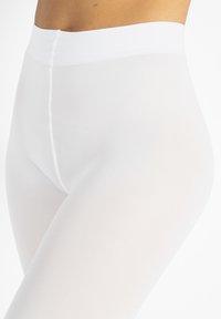 Leggings bianchi con una finitura liscia e texturizzata, dotate di una vita alta e una silhouette aderente, ideali per comfort e versatilità.