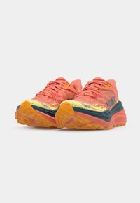 Trail running shoes featuring a vibrant pink and orange mesh upper, thick multi-colored sole, and patterned tread for traction.