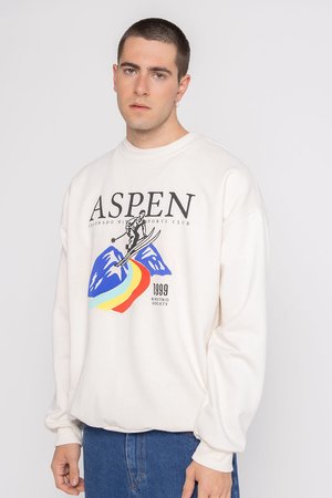 Krémová mikina s nápisom "ASPEN", lyžiarskou grafikou, dizajnom dúhy a rebrovanými manžetami. Mäkko materiál s voľným strihom.