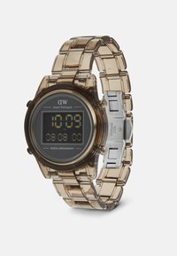 Orologio cronografo digitale con cinturino trasparente in resina marrone, quadrante rotondo, display digitale nero e dettagli in acciaio inox argentato.