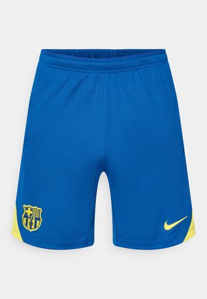 Shorts de sport bleus en tissu respirant. Présentent un logo Nike jaune et un accent jaune sur les côtés, avec un emblème de club sur la gauche.
