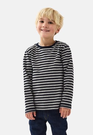 Striped long-sleeve shirt in gray and navy, made from soft fabric. Features a crew neckline and a relaxed fit. Paired with blue jeans.