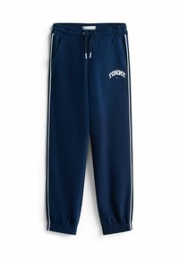 Marineblauwe joggingsbroek met een drawstring taille, zijkanten met zakken en witte zijsstripes. Opvallend "TOMMY" logo geborduurd op de linkerbovenbeen.