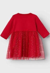 Abito rosso con maniche lunghe, top in tinta unita e gonna in tulle decorata con motivi a stella dorati, con scollatura rotonda e tessuto morbido.