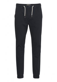 Navy blue tapered pants in lightweight cotton with elastic cuffs, a drawstring waistband, and contrast stitching detail.
