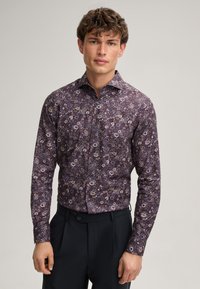 Lila Langarmshirt mit einem floralen Muster in verschiedenen Farben. Hemd-Design mit Knöpfen, klassischem Kragen und taillierter Form.