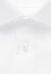 Weißer Hemdkragen und Vorderseite mit sichtbarem Knopf, zeigt sauberen Stoff und ordentliche Nähte.