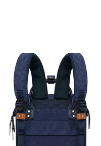 Navy-blue fabric backpack with padded straps, metal accents, and leather details. Features textured surface and adjustable features.