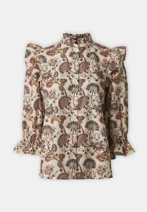 Blus med blommönster i beige med volangaxlar och hög hals. Har knäppning fram och långa ärmar med rynkade manschetter.