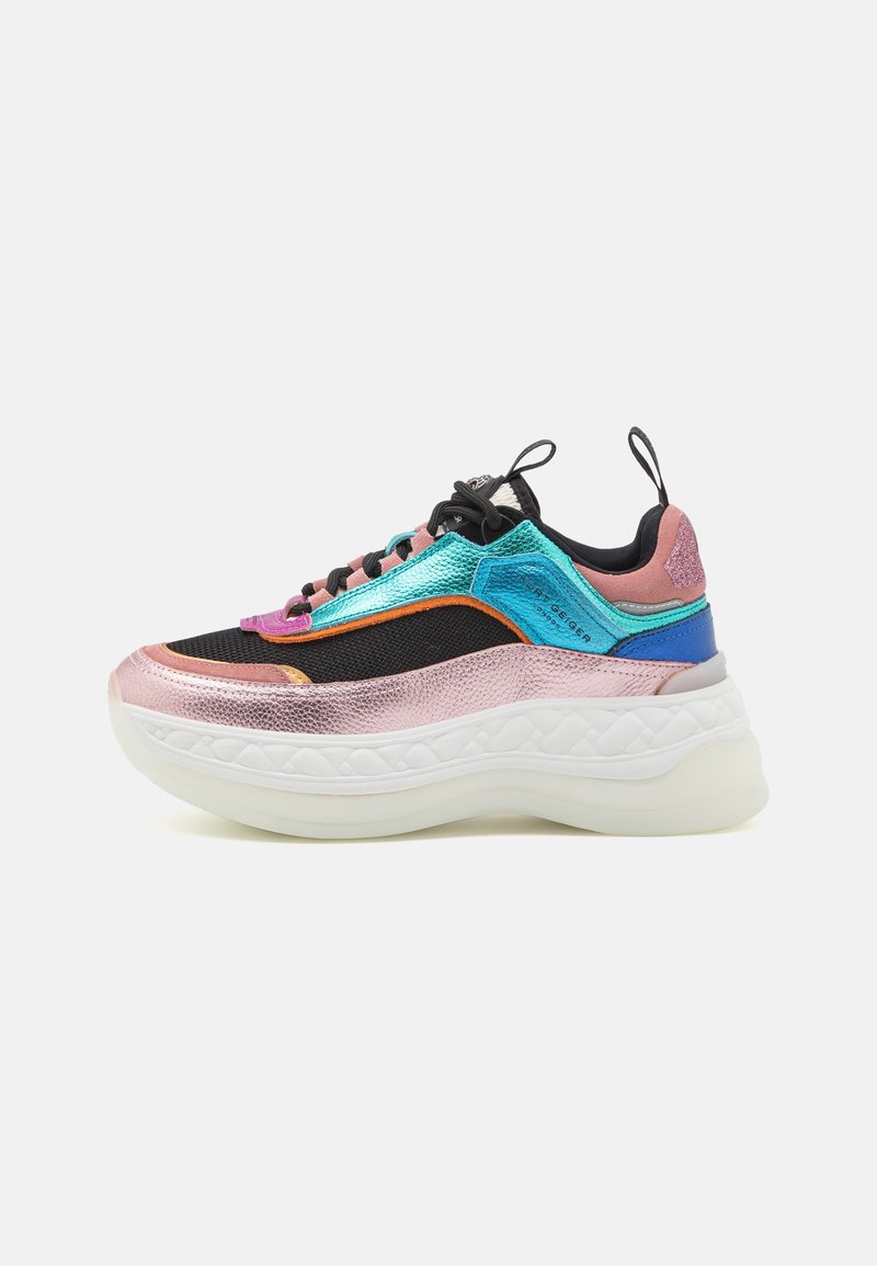 Multicolor sneaker featuring a mix of shiny black, blue, pink, and metallic textures. Thick white sole with a padded midsection and laces.