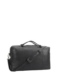 Sac de voyage en cuir noir avec double poignées, bandoulière amovible et fermeture éclair supérieure. Présente une surface texturée et un design minimaliste.