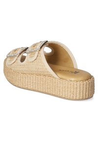 Beige platform sandals with woven texture, two decorative straps with rhinestone buckles, and a rounded open back design.