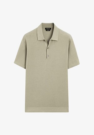 Polo shirt beige à manches courtes avec des manches et un ourlet côtelés, patte de boutonnage à deux boutons et col classique.