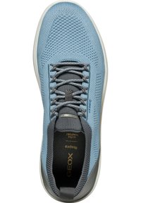 Scarpa atletica azzurro chiaro con tomaia in rete, dettagli grigi e chiusura con lacci. Presenta una suola ammortizzata e un motivo testurizzato sul tessuto.