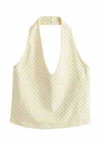 Haut court crème à col licou avec petits motifs de cœurs noirs et un décolleté plongeant en V.