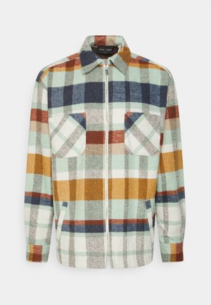 Chaqueta camisa para hombre con cremallera y patrón de cuadros multicolores en azul, mostaza, óxido, crema y gris, con dos bolsillos en el pecho y cuello.