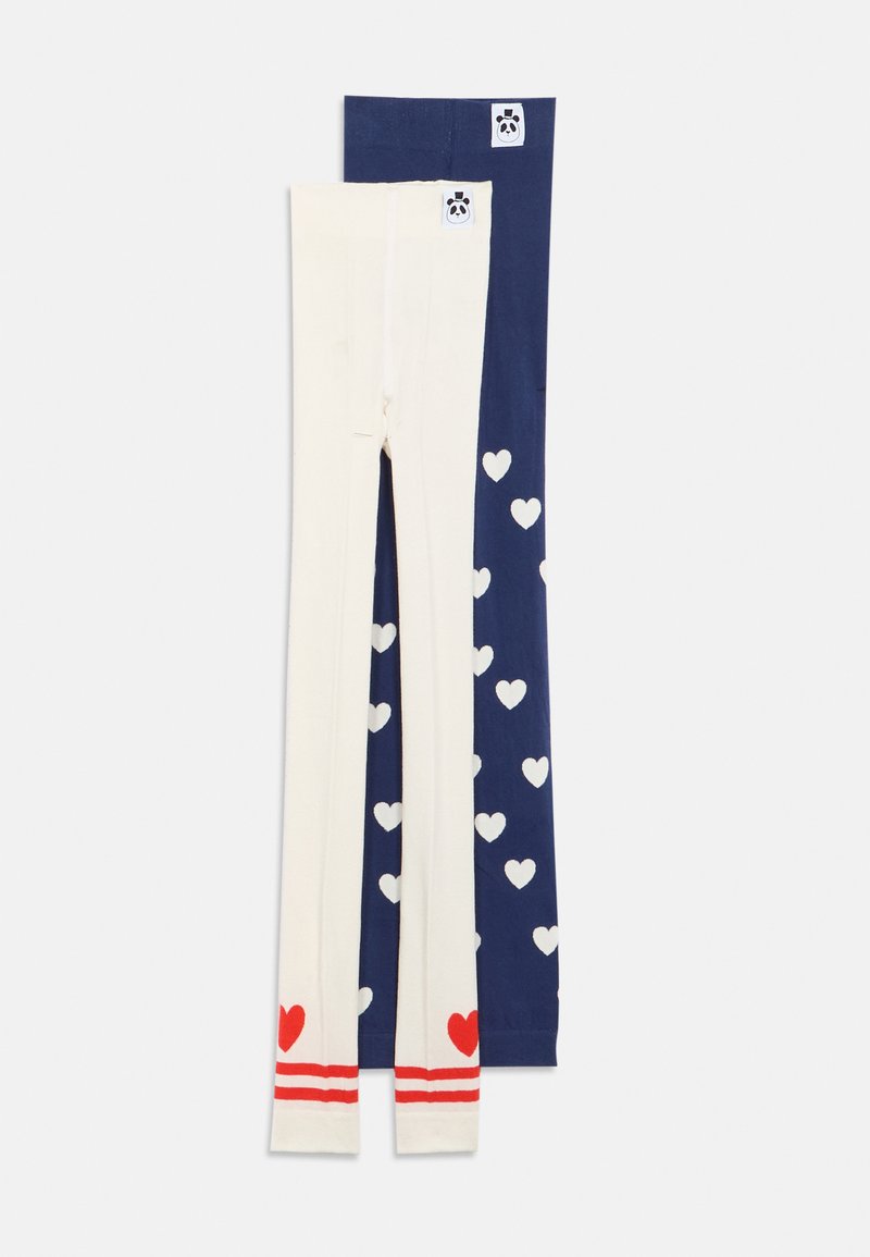 Duas meias-calças infantis, uma azul-marinho com corações brancos e outra creme com corações vermelhos e riscas, ambas com uma pequena etiqueta de panda na cintura.